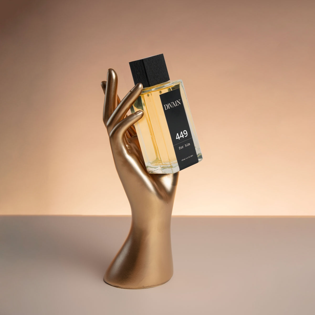 Perfume divain-449 held by a golden-coloured wooden hand