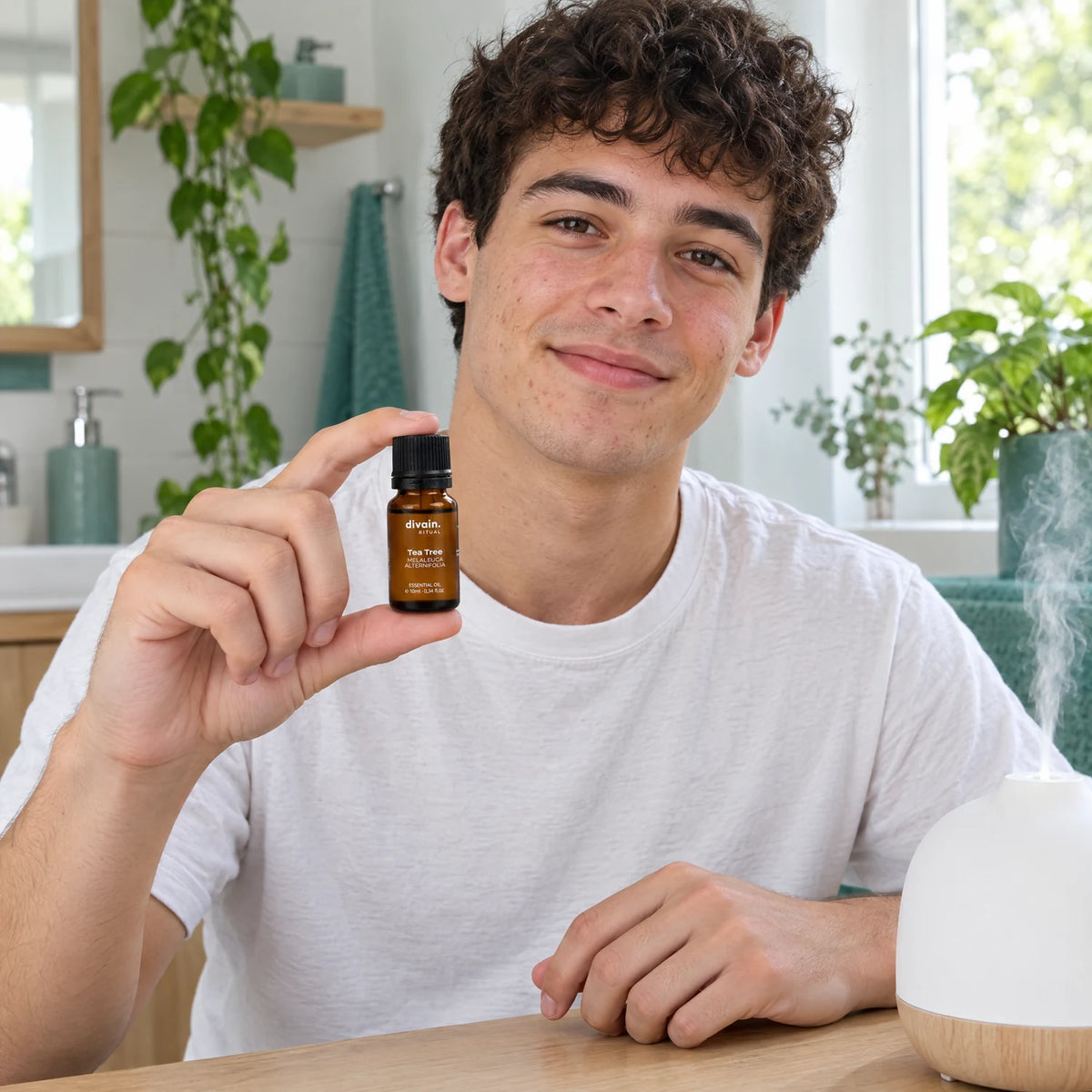 Chico joven en el baño con el aceite esencial de árbol de té