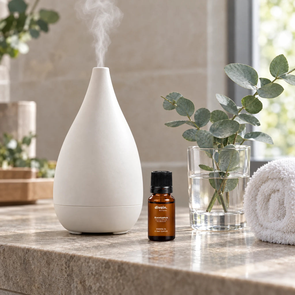 Aceite esencial de eucalipto en un baño tipo spa junto a un difusor