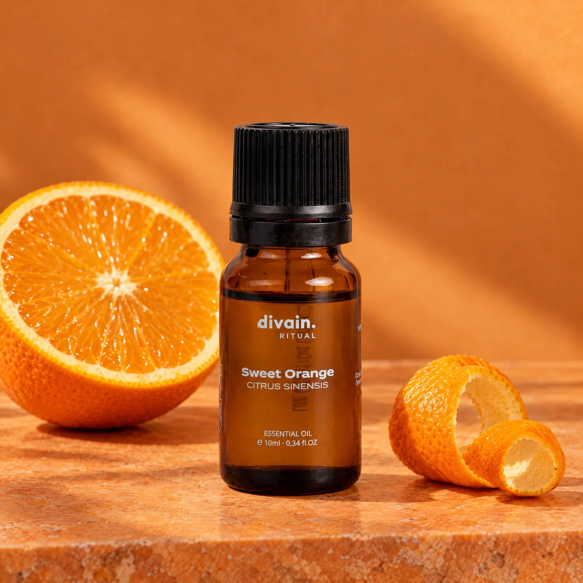 Aceite esencial de naranja dulce con media naranja y piel de naranja