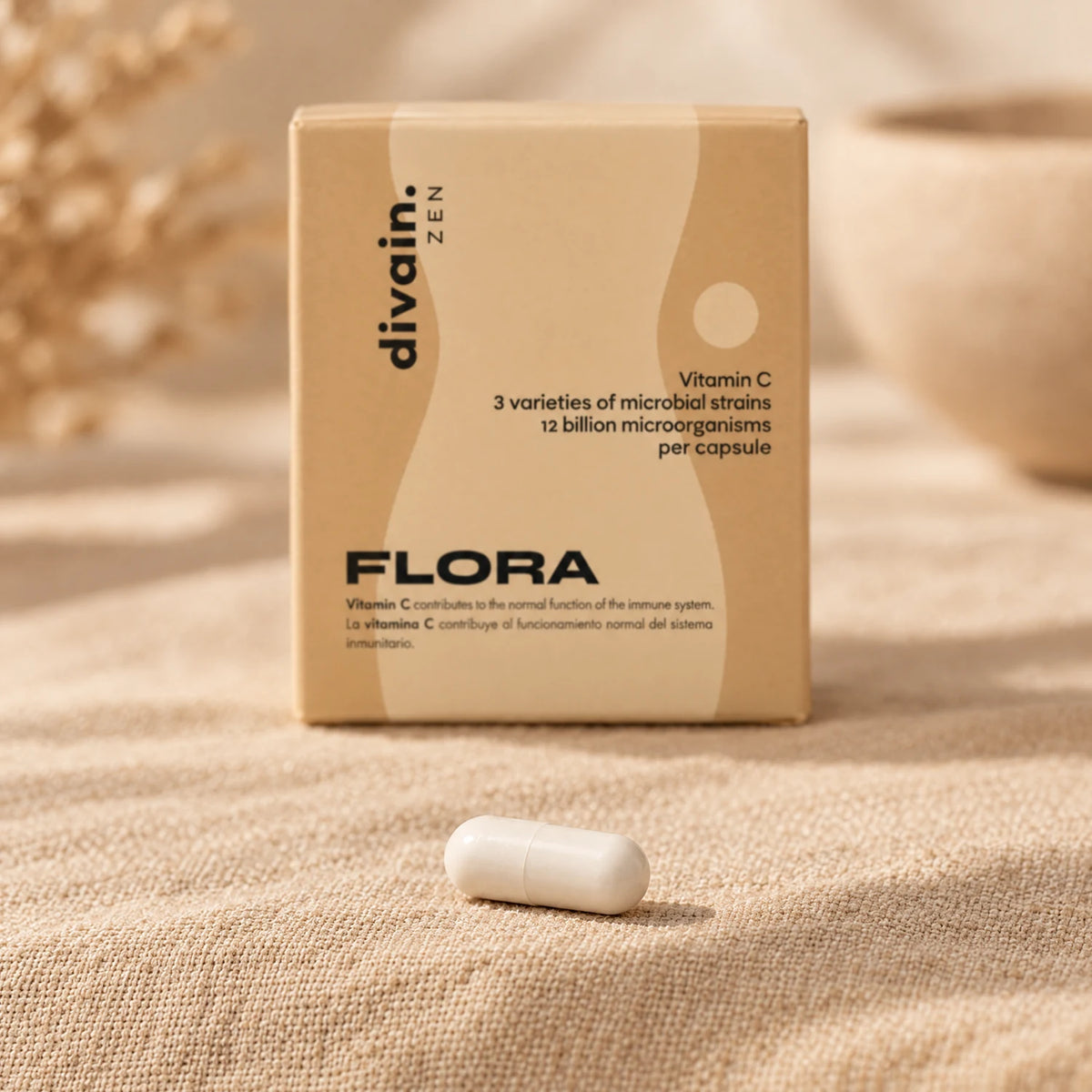 Cápsula de FLORA delante de su caja